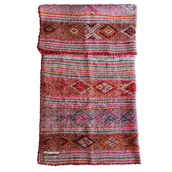 Multicolored patterned blanket with brand label on a white background