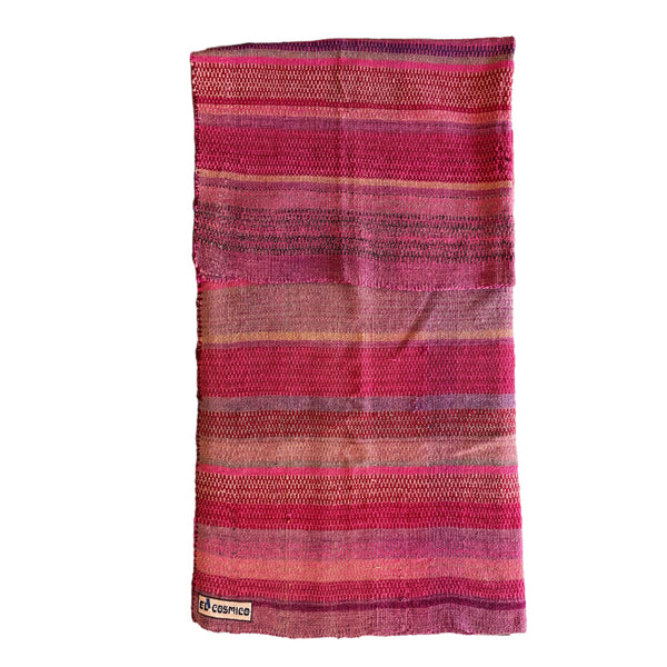 Striped fabric with pink and purple hues on a white background